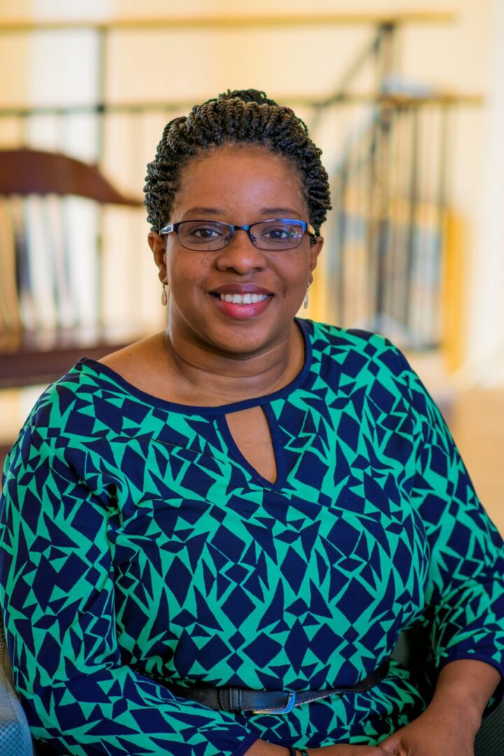 A woman in glasses and a blue shirt