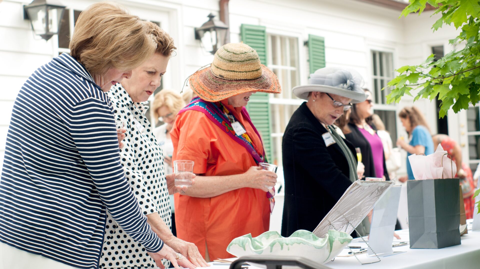 A group of people standing around a table.