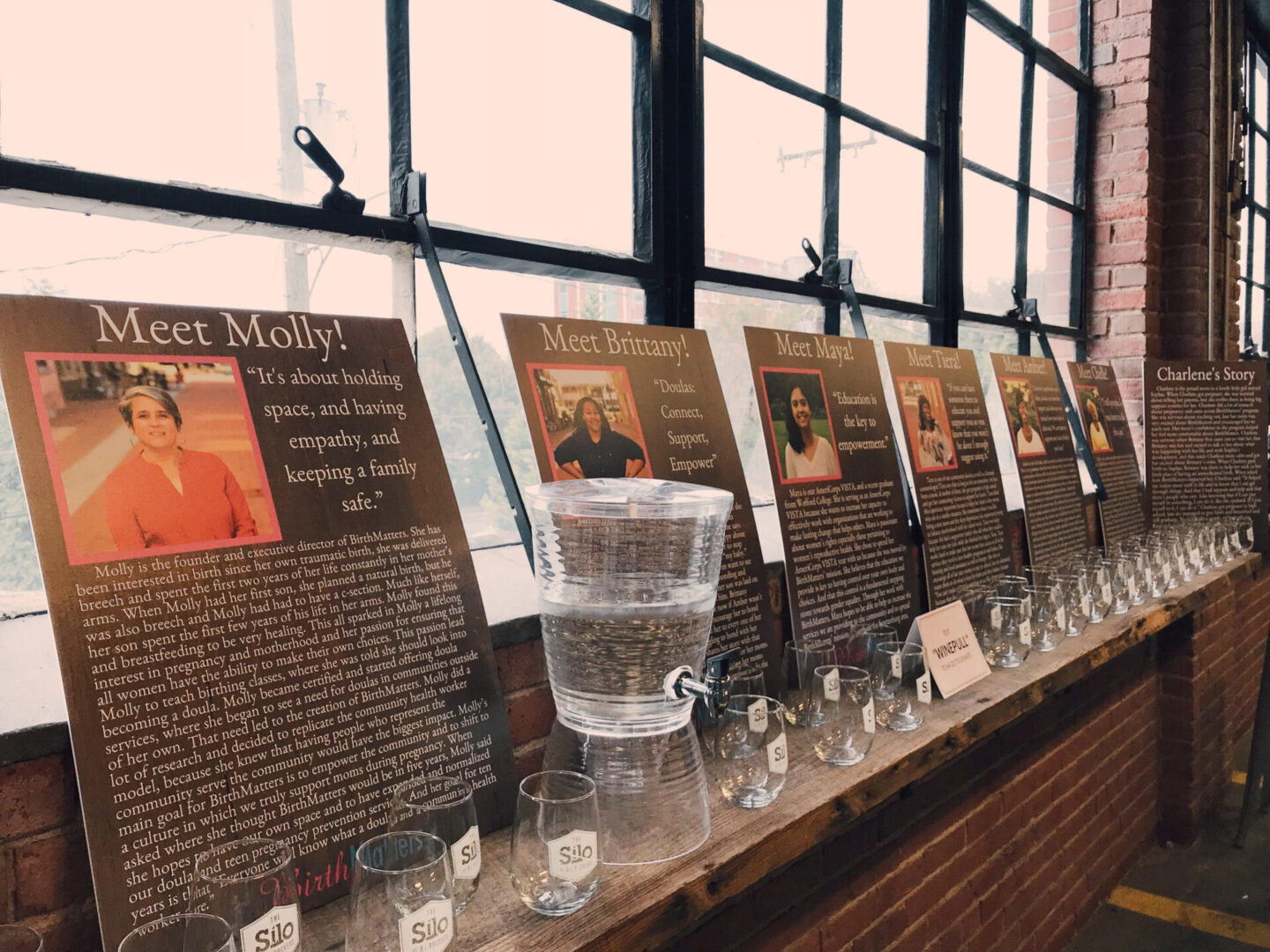 A row of pictures on display with glasses.