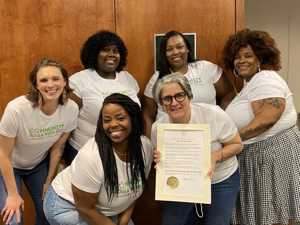 A group of women holding up a certificate.